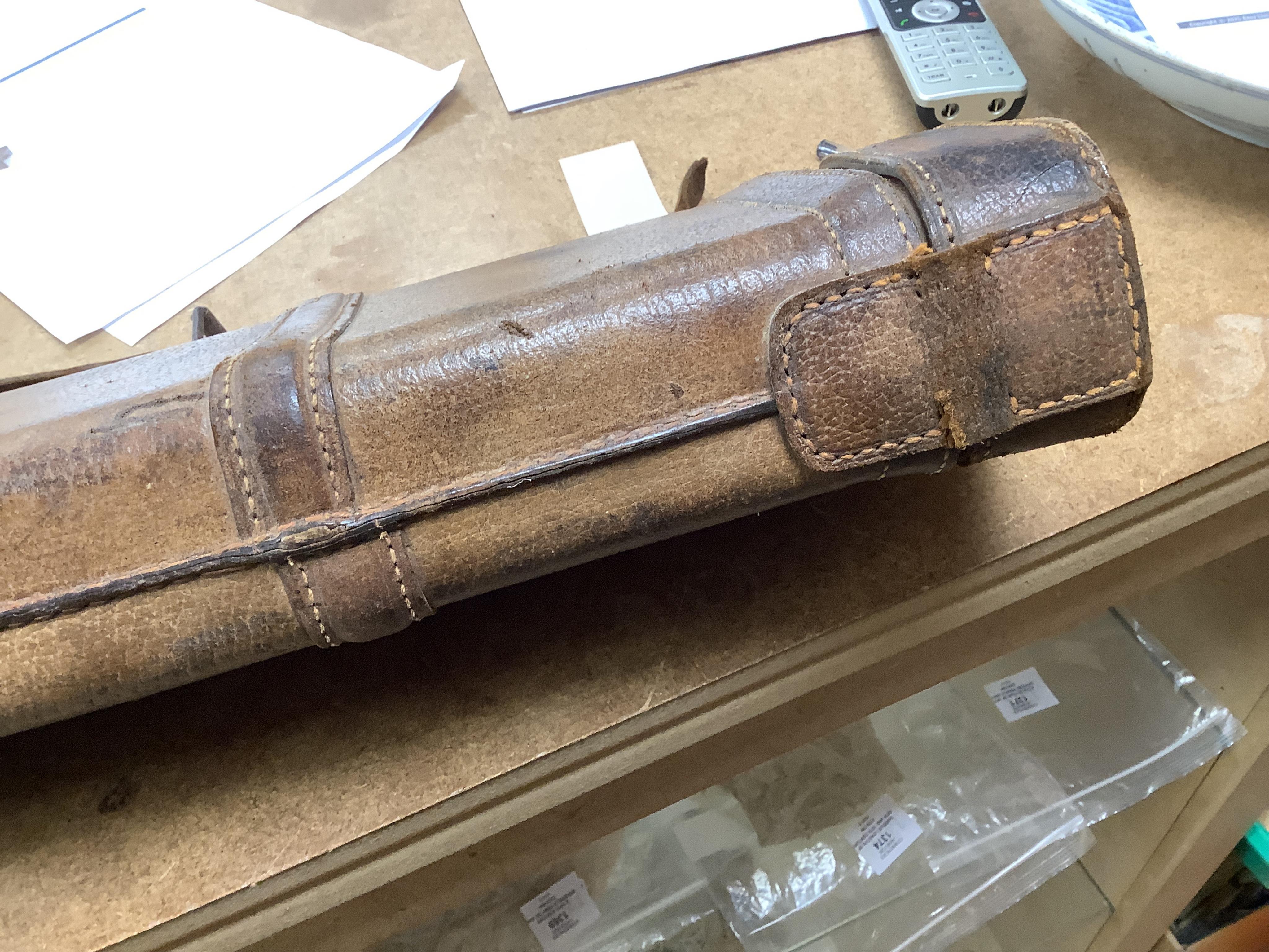 A 'Leg of Mutton' leather gun case and a top hat in leather case, gun case 75cm long.